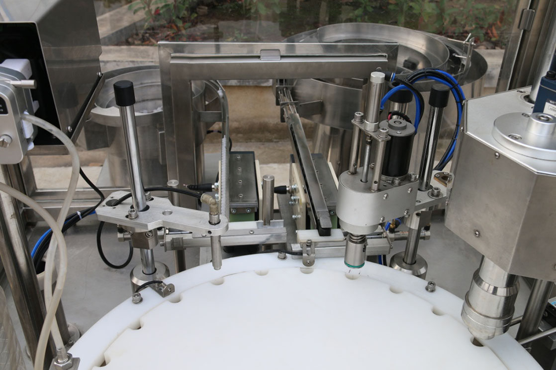 Small bottle filling, plugging and capping machine14